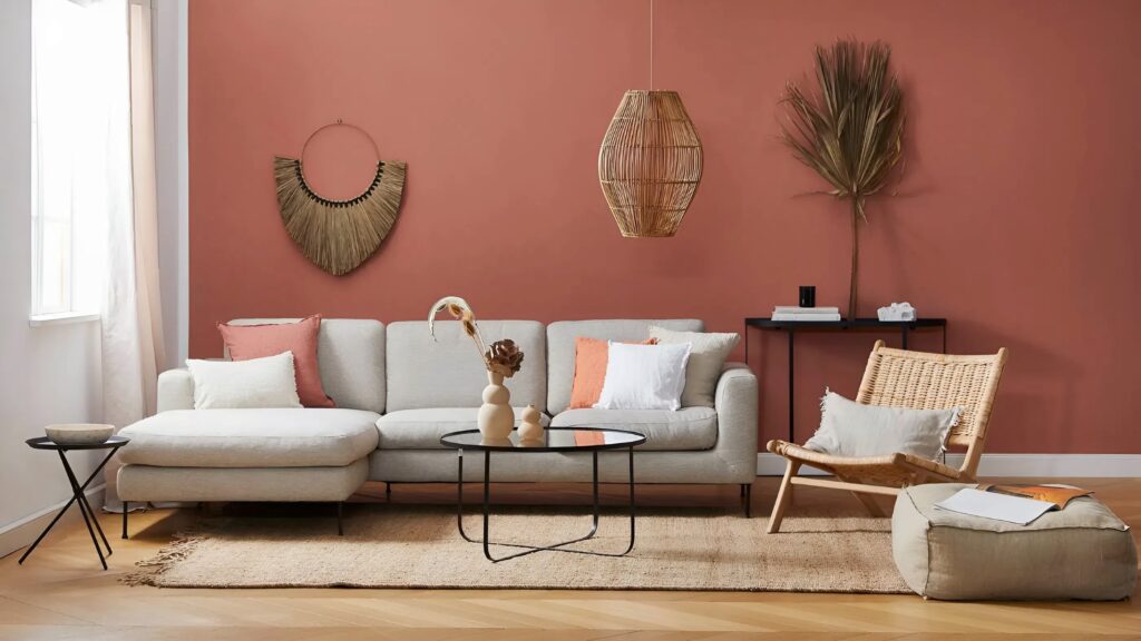 Living room with rich terracotta accent wall and neutral furnishings by a house painter in South Carolina