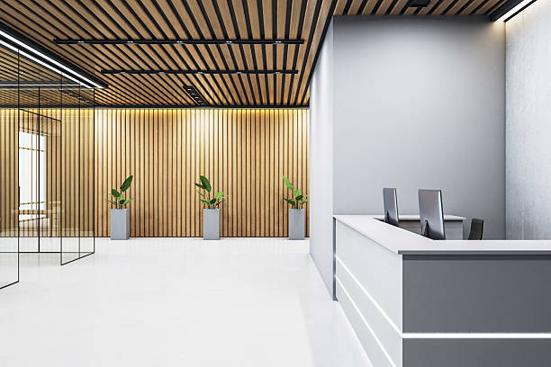 Reception area with soft gray walls, crisp white surfaces, and natural wood slat accents by a painting company in Mount Pleasant, SC.