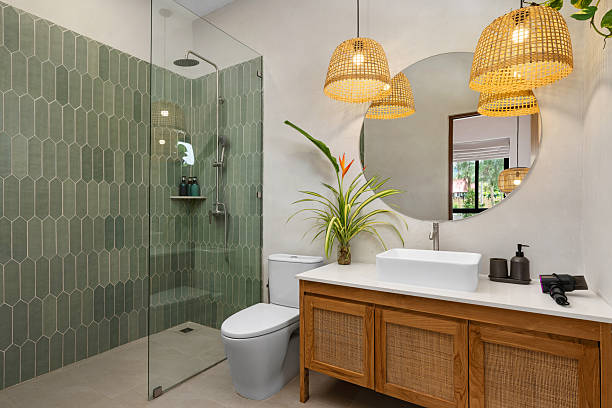 Modern bathroom with sage green walls and bright white accents by an interior painter in Annapolis, MD.